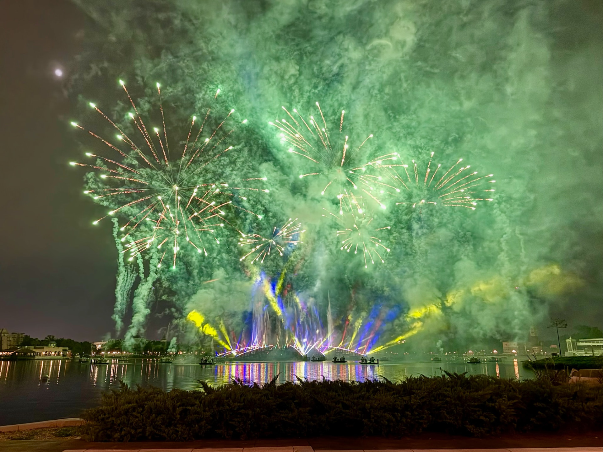 Green fireworks over the EPCOT lagoon