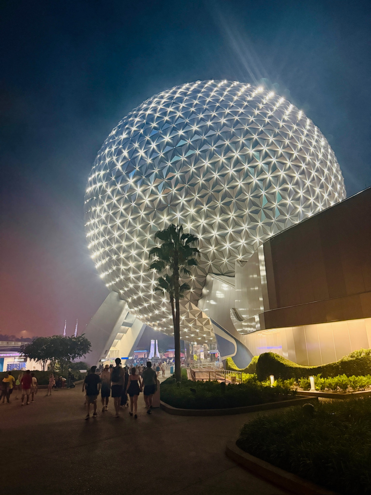 Spaceship Earth glowing at EPCOT at night